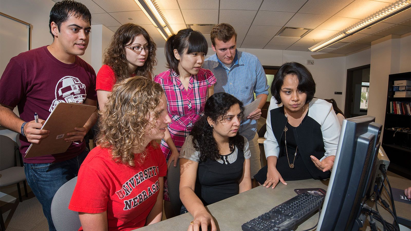 A group of students around a computer