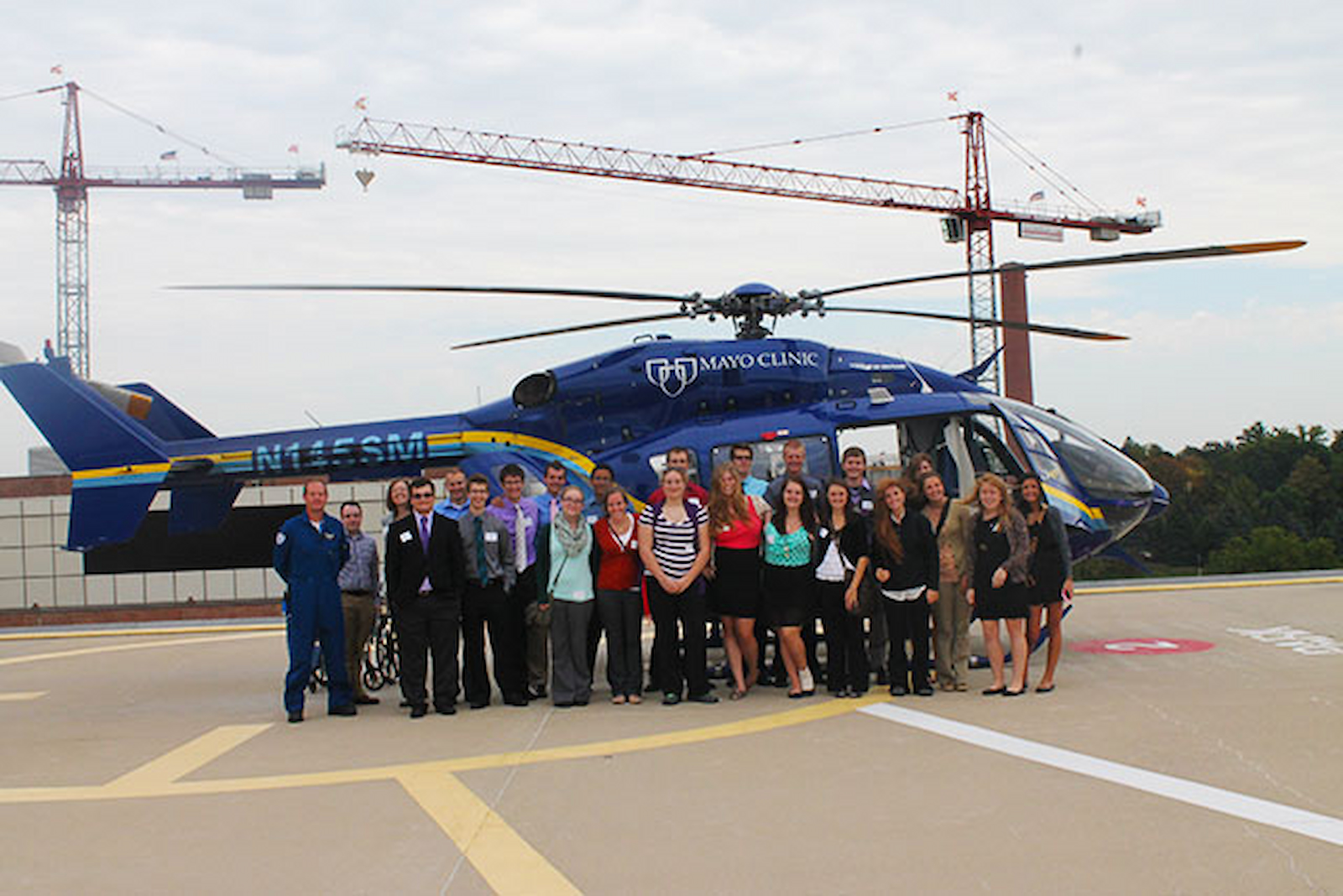 Exploring Health and Medicine students pose in front of Mayo Clinic helicopter