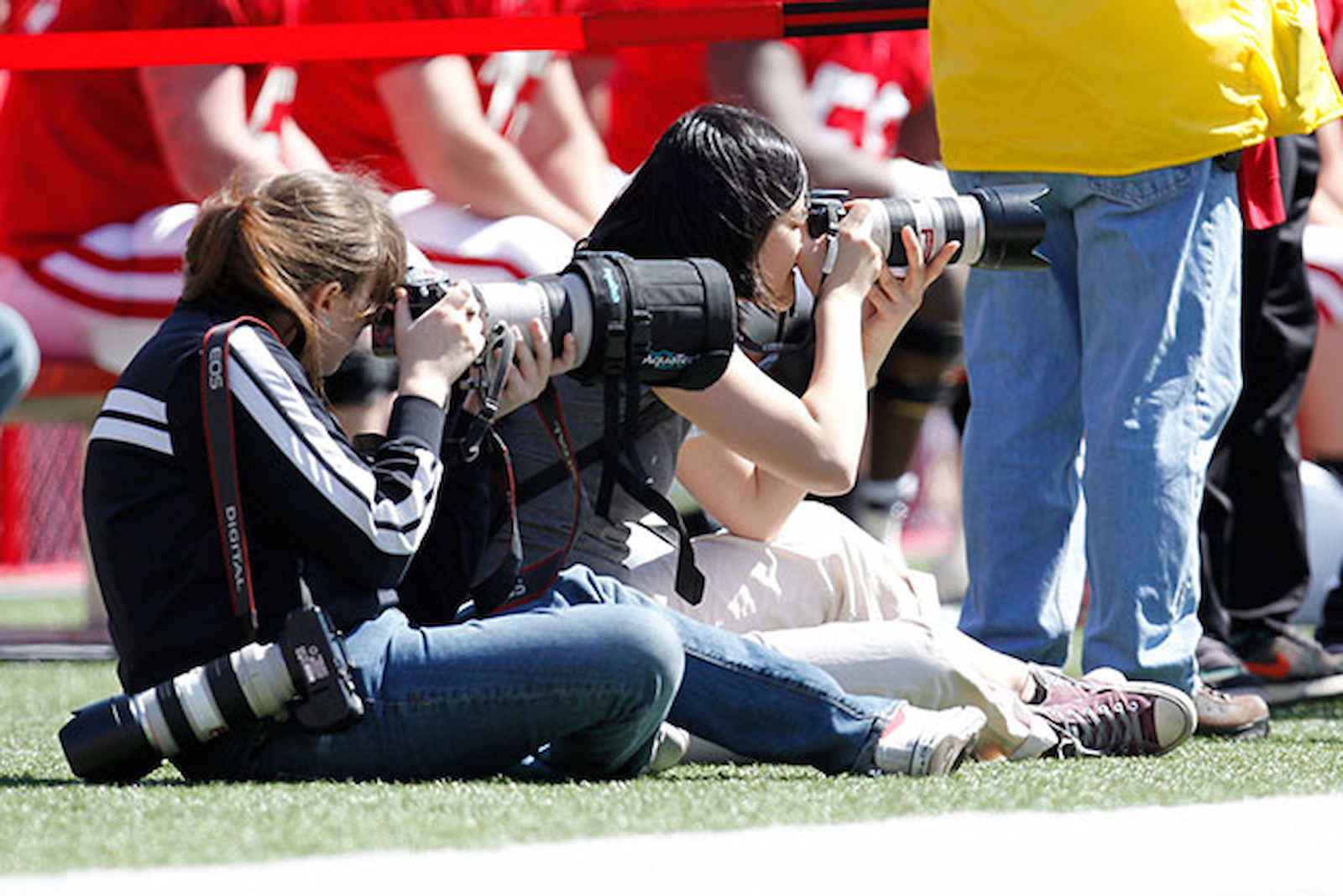 Press photographers taking photos during a sporting event