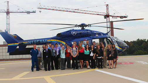 Exploring Health and Medicine students pose in front of Mayo Clinic helicopter