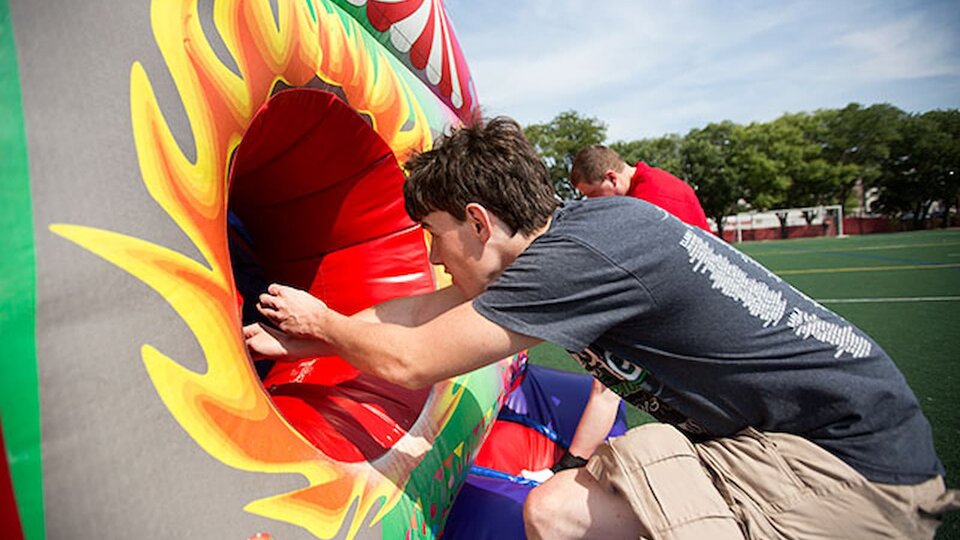 Students running through inflatable obstacle course