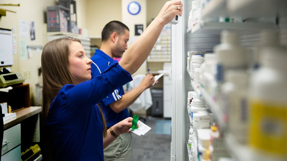 Pharmacy students preparing medications