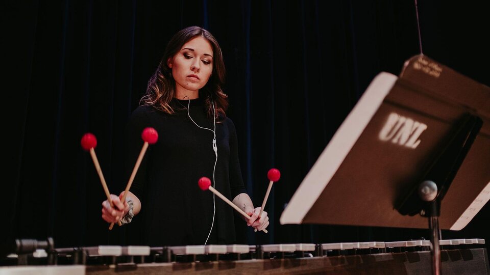 Student playing instrument during performance