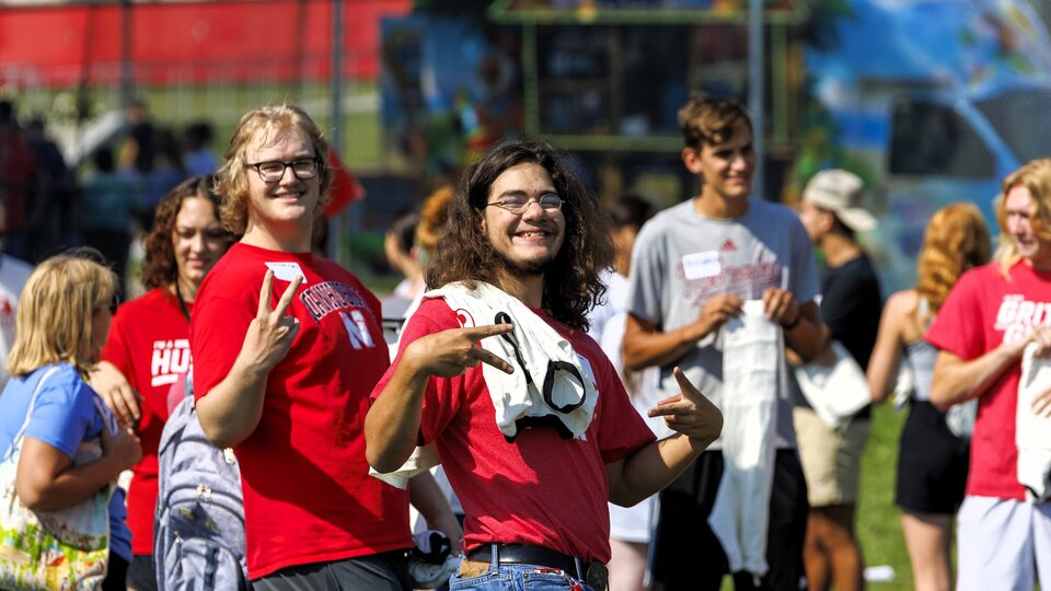 Students at the LC Welcome Event showing peace signs