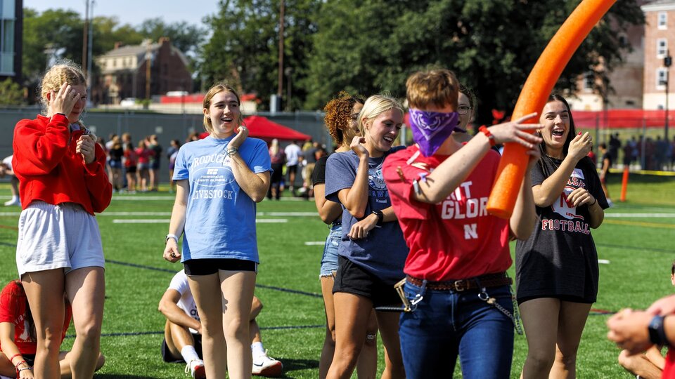 Students at the LC Welcome Event playing pool noodle ninja